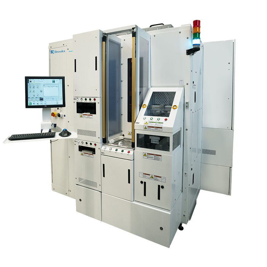 Large white industrial semiconductor processing machine with control panel, computer monitor, reticle management features, warning labels, and indicator lights, isolated on a white background.